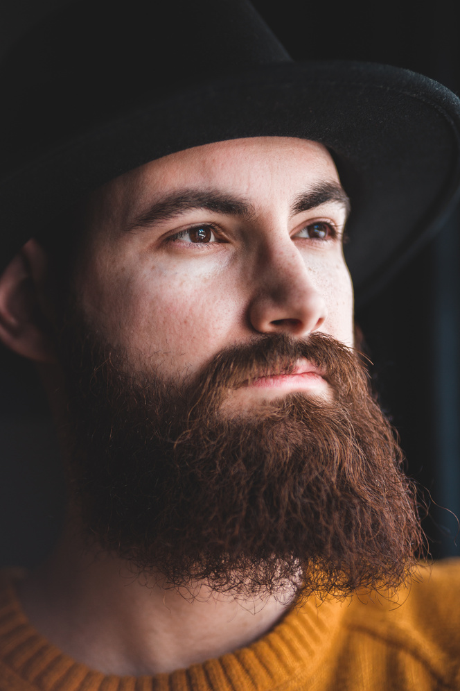 Stylish young bearded man looking away
